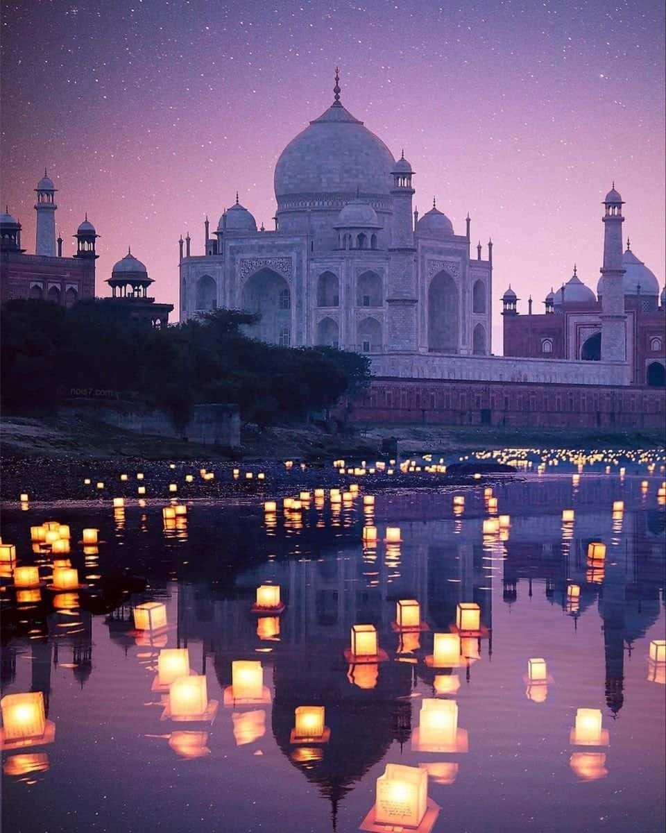 Taj Mahal at night glowing under moonlight with a dark sky background