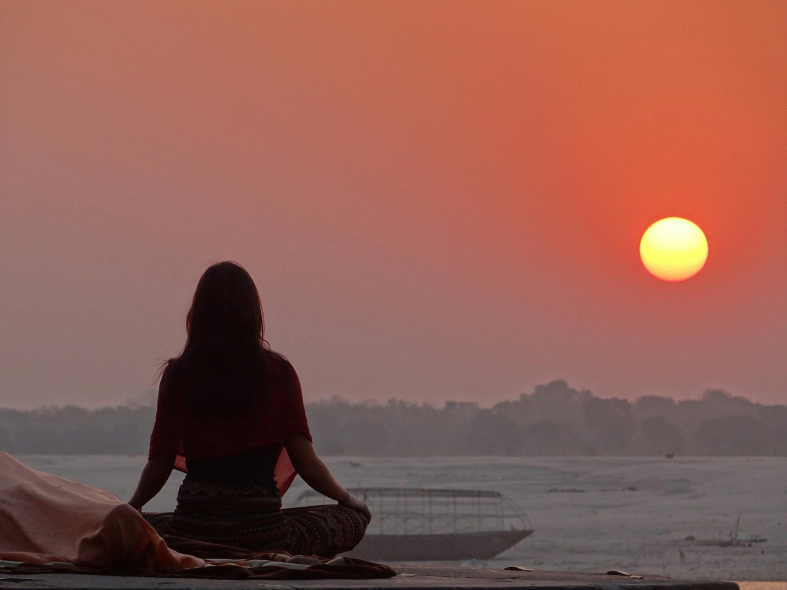 Morning meditation by the Ganges in Varanasi
